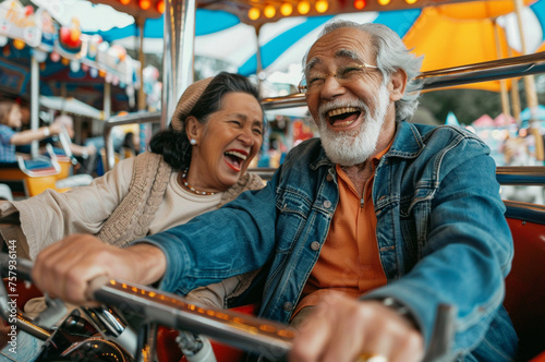 Senior concept - senior couple enjoy themselves at amusement park
