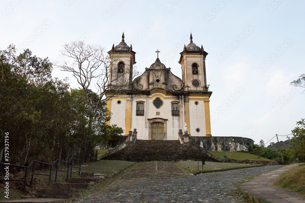 Image shows the facade of the Church of São Francisco de Paula in Ouro Preto in the late afternoon