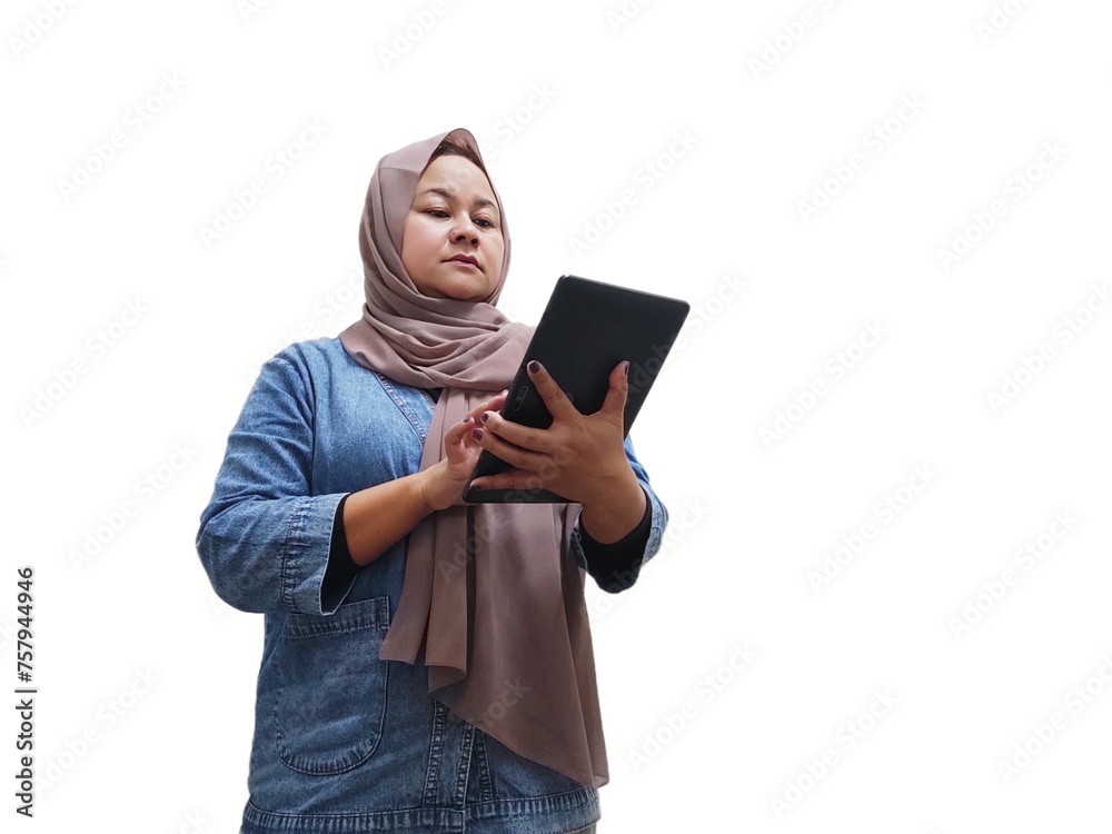Asian Muslim woman in hijab, standing holding and looking smart mobile tablet. Isolated on white background.