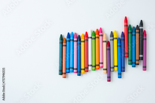 A large set of multi-colored children's wax crayons on a white background.