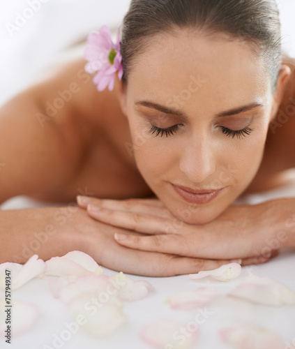 Zen, massage and face of woman at spa for health, wellness and balance with luxury holistic treatment. Self care, relax and girl on table for body therapy, comfort and calm pamper service at hotel