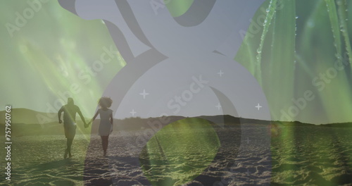 Image of grass over happy african american couple running on beach