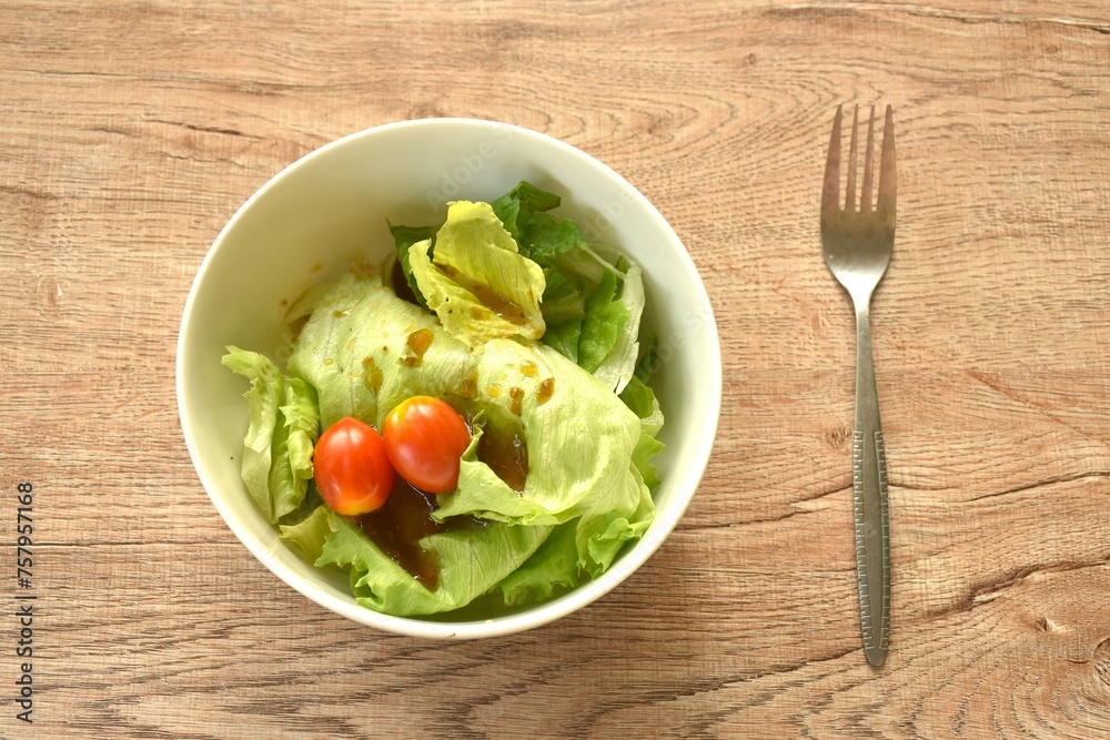 cos and tomato salad dressing Japanese sesame soy sauce on bowl cos and tomato salad dressing Japanese sesame soy sauce on bowl