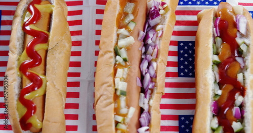 Image of white and red stripes and human silhouette over hot dogs