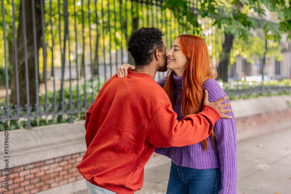 Fototapeta premium Affectionate couple embracing in a warm multiracial embrace
