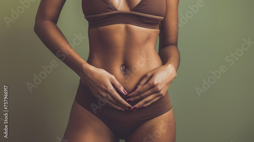 Confident Beauty in Wellness - Close-up of Fit Female Torso in Chic Sportswear on Olive Green Background