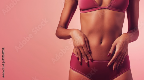 Elegance in Fitness - Sleek Sportswear on a Woman's Torso Against a Soft Pink Background