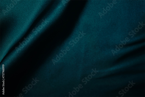 Emerald green silk or satin, draped fabric, elegant background. Beautiful wavy space for design Close-up images are blurry or blurred.