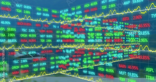 Image of trading board and graphs over airplane landing on runway