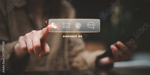Contact us, Customer service. Businesswoman touching on virtual screen contact icons to call, email, address or live chat. Online support concept photo