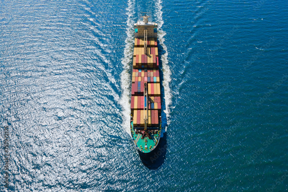 Container ship cruising open ocean sea for logistics import export, shipping or transportation, Aerial top view