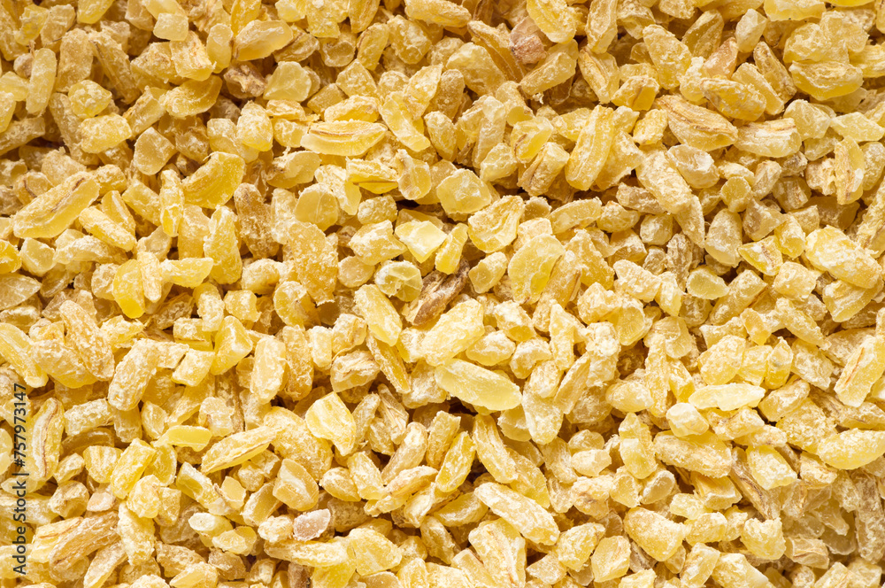 Dry bulgur wheat grains texture background. Heap of uncooked bulghur , cereal food