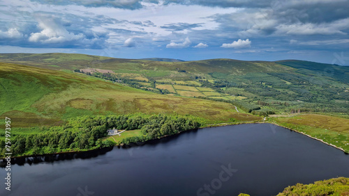 From the heights of the peak, Lough Bray Lower unfolds below like a breathtaking painting. © Ross