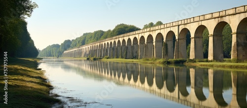 Majestic Stone Bridge Spanning Over Calm Waters in a Serene Natural Landscape