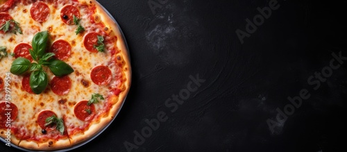 Delicious Pizza with Pepperoni and Fresh Basil Leaves on Stylish Black Background