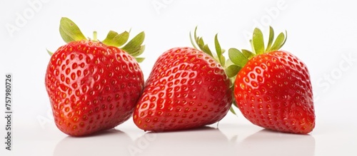 Vibrant Trio of Ripe Red Strawberries on a Clean White Background