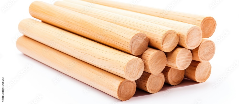 Rustic Wooden Dowels Piled on a Clean White Background for Crafts and Construction Projects
