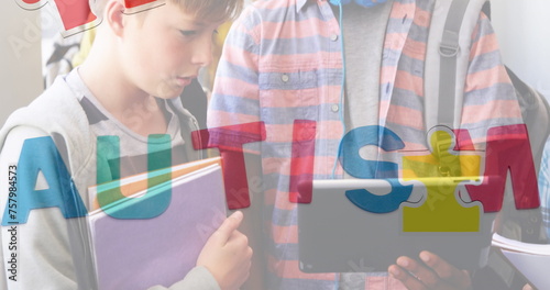 Image of autism text over diverse schoolchildren using tablet