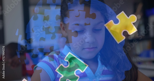 Image of puzzle pieces over biracial schoolgirlusing tablet