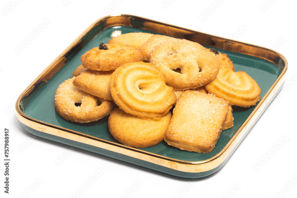Group of assorted of danish butter cookies in a green plate isolated on white background clipping path