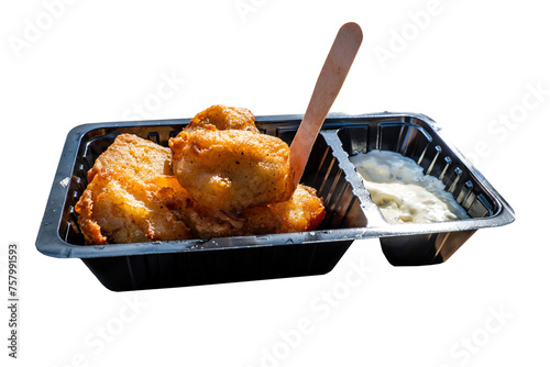 A portion of kibbeling with garlic sauce. Kibbeling is a Dutch snack consisting of battered chunks of fish