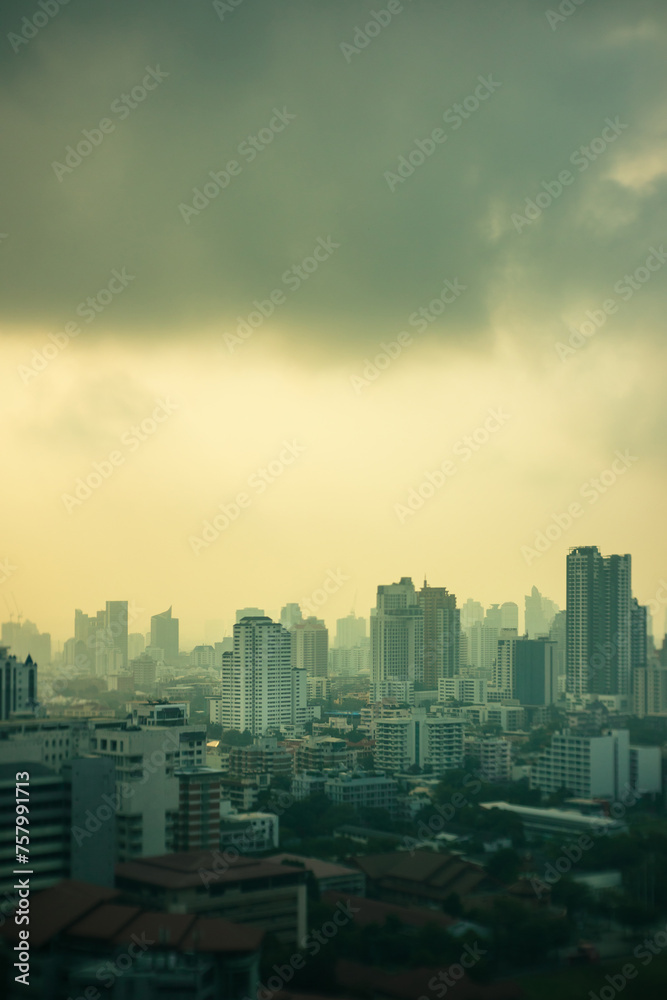 smog city in summer with morning sunlight, haze of pollution covers city, global warming and climate change concept, selective focus