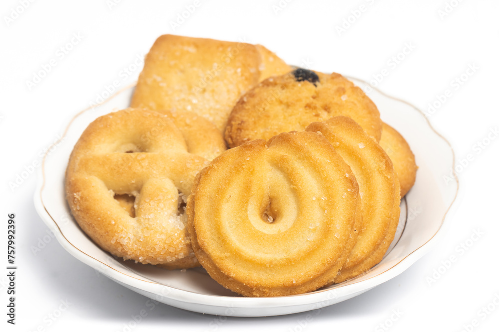 Group of assorted of danish butter cookies in a small white plate isolated on white background clipping path