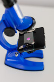 Close up of blue microscope on table
