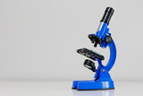 Blue metal microscope standing on table with copy space