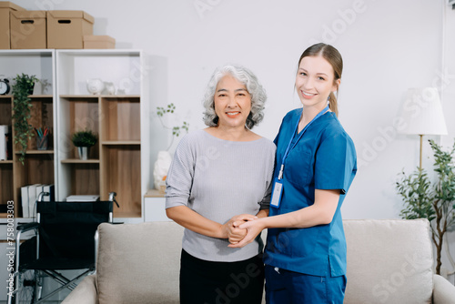  Young Caregiver doctor examine older patient use blood pressure gauge. woman therapist nurse at nursing home taking care of senior elderly woman sit on sofa.
