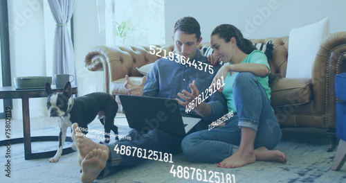Image of numbers changing over caucasian couple using laptop