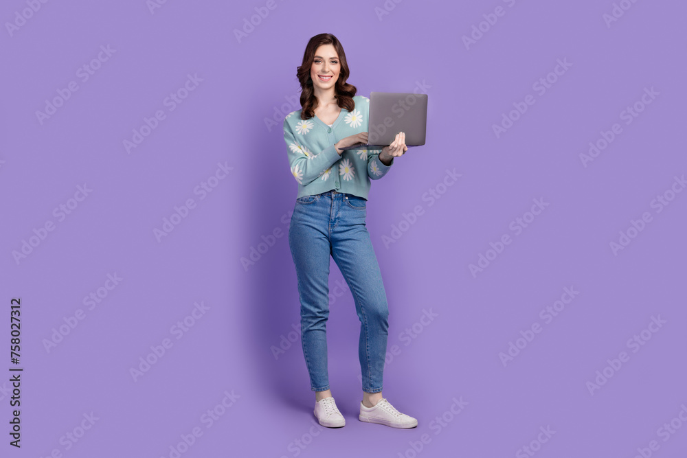 Full length photo of sweet cute woman wear flower print cardigan working modern gadget isolated purple color background Full length photo of sweet cute woman wear flower print cardigan working modern gadget isolated purple color background