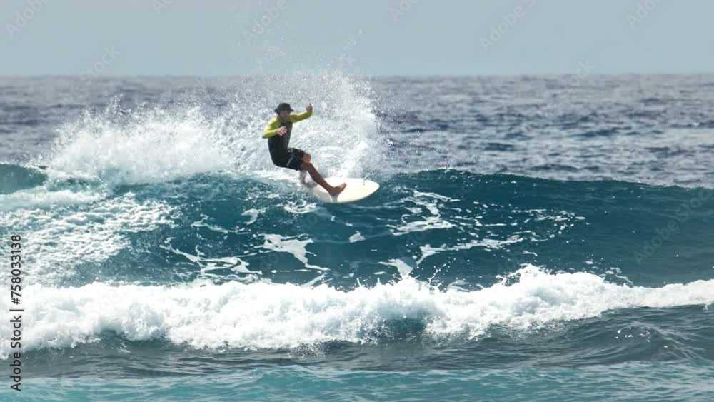 Surfer rides the wave in the Maldives Surfer rides the wave in the Maldives