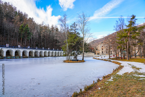 Aqueduct along the frozen lake of the Parc de la Schappe in Briançon, a small town of the Hautes-Alpes department in the French Alps