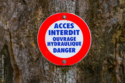 Warning sign prohibiting access because of a danger at a hydraulic plant in the Parc de la Schappe in Briançon, France