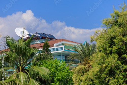 Southern cityscape, view of buildings and houses, palm trees and mountains, in public places in Turkey, sunny summer day in a resort town