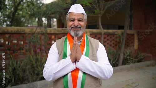 An Indian political party leader joining his hands in front of the camera - general elections  neta ji  voting. A politician folding his hands and requesting the people to give him support and vote... photo