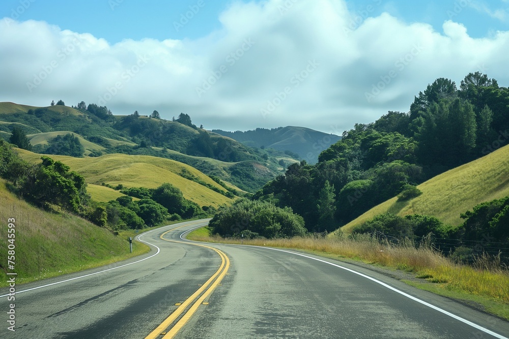 A picturesque view of a smooth, winding road slicing through vibrant green hills under a bright blue sky dotted with fluffy white clouds, invoking a sense of calm and the allure of the open road.