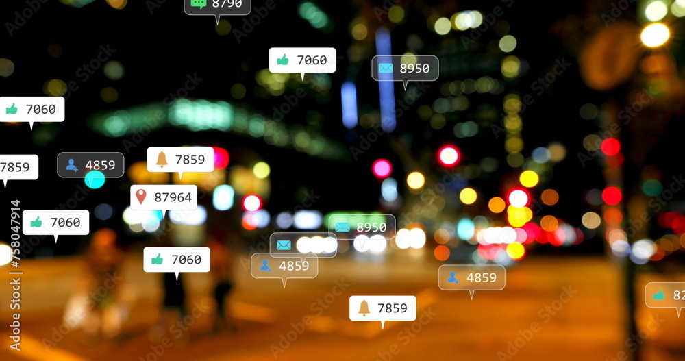Image of social media icons and numbers over out of focus city lights Image of social media icons and numbers over out of focus city lights