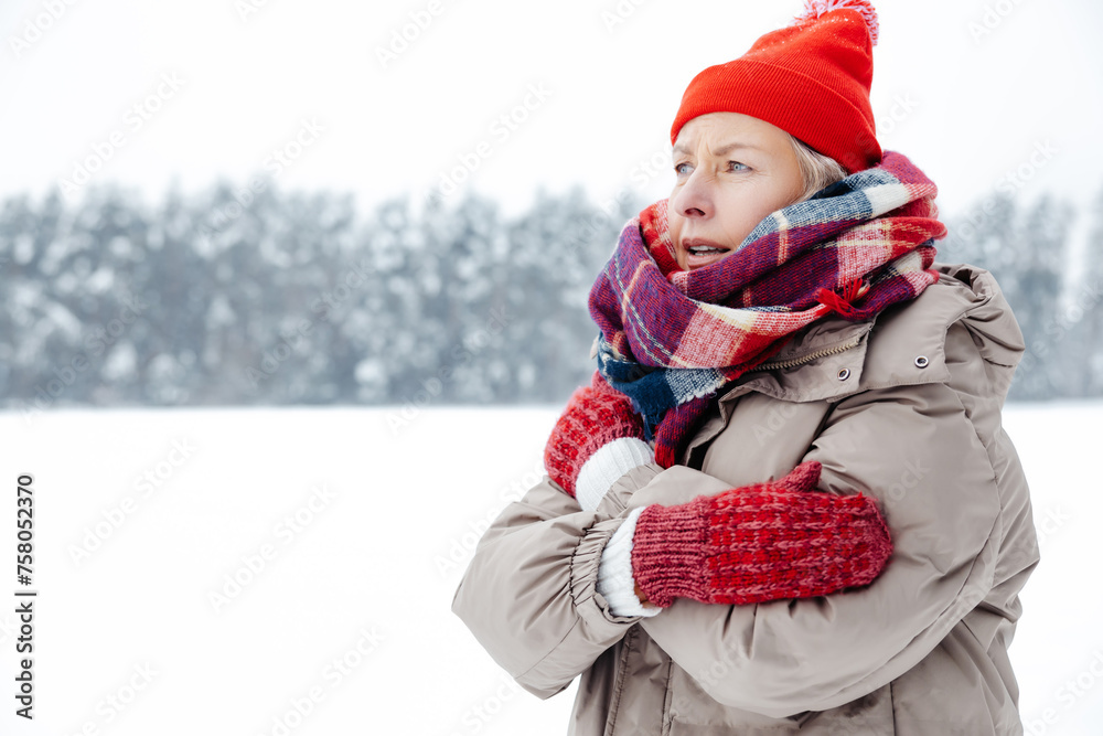 Woman red hat and checkered scarf feeling cold and shivering Woman red hat and checkered scarf feeling cold and shivering
