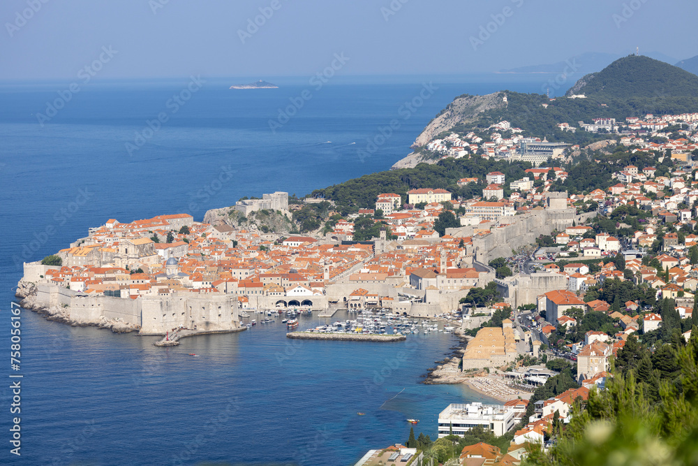 Aerial view of Old Town (Stari Grad), city ​​walls and a port for tourist ships by Adriatic Sea, Dubrovnik, Croatia