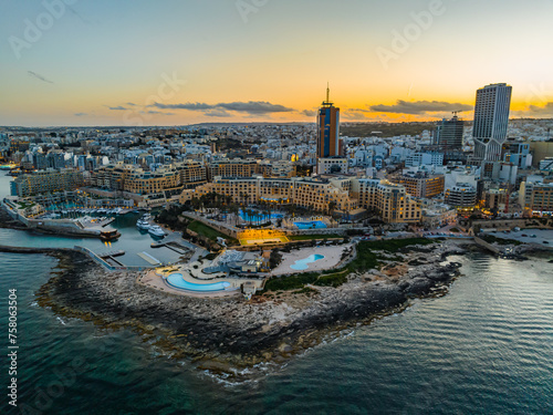 Tableau sur toile St. Julian's city, high buildings. Sunset sky. Maltese island