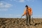 Man with a metal detector in the field. Search for treasures.
