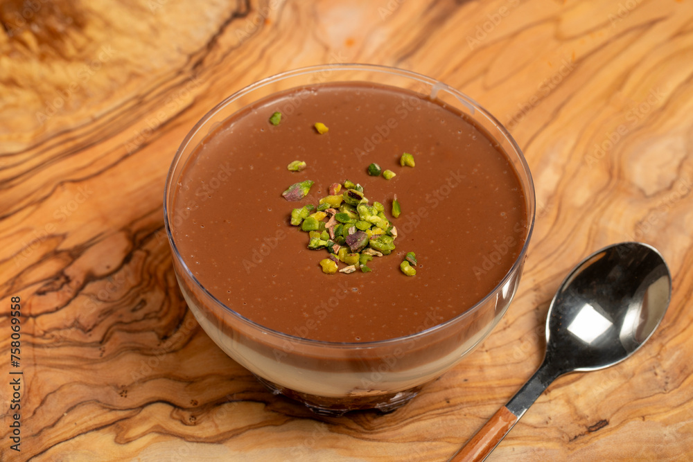 Chocolate pudding dessert. Supangle dessert with cream and chocolate pudding on a wooden serving board Chocolate pudding dessert. Supangle dessert with cream and chocolate pudding on a wooden serving board