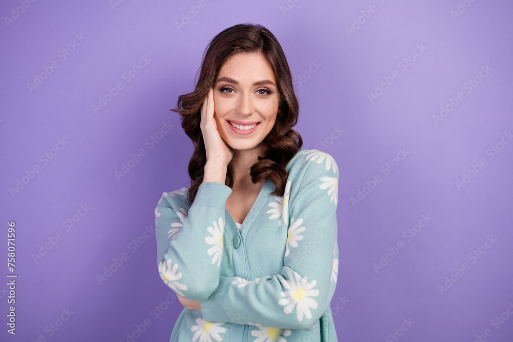 Portrait of brunette curls girlfriend touch cheek and poses feminine girlish satisfied wearing cardigan isolated on purple color background Portrait of brunette curls girlfriend touch cheek and poses feminine girlish satisfied wearing cardigan isolated on purple color background