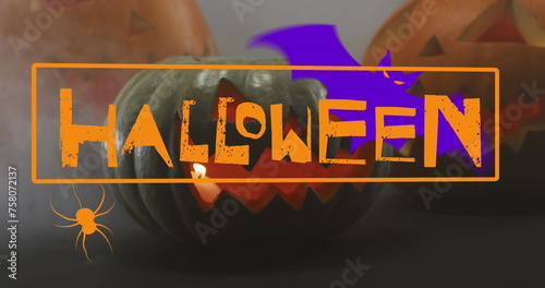 Image of happy halloween text with bat and spider over carved pumpkins