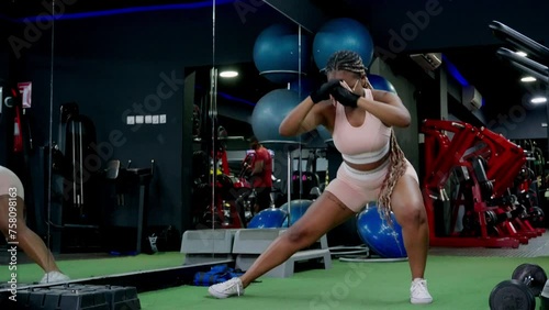 Young black woman in the gym exercising