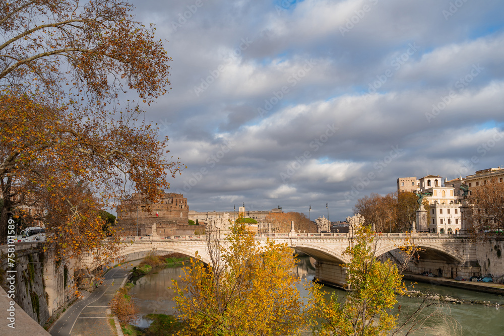daytime winter cityscape of a bridge and tiber river in rome