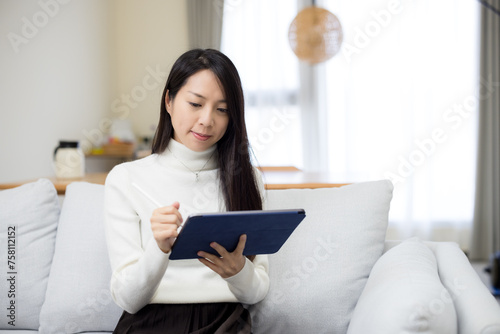 Woman use tablet computer at home