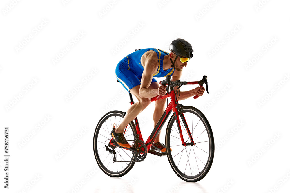 Obraz premium Concentrated and motivated man in sportswear and helmet, bicyclist in motion, training isolated on white studio background. Concept of sport, active and healthy lifestyle, speed, endurance, hobby